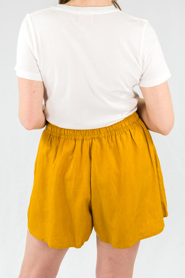 Back view of model wearing A-Line High Rise Linen Tencel Blend, carbon neutral Shorts